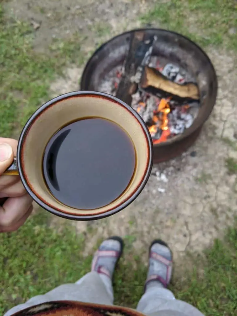 Half Full Coffee Cup above cracking fire