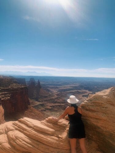 Woman With Black Outfit With White Hat Gazing At The Grand Canyon